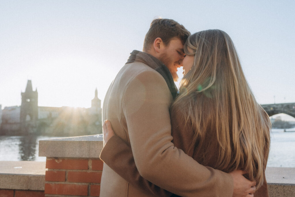 Couple enjoying winter photoshoot near Charles Bridge in Prague