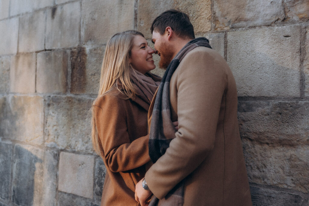Romantic winter photoshoot of a couple on Charles Bridge, Prague