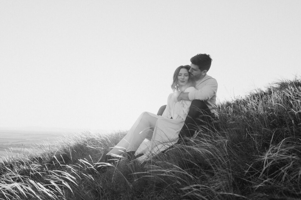 Couple embracing at sunset in natural landscape near Prague