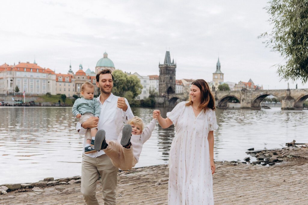 Family enjoying photoshoot near Charles Bridge, Prague