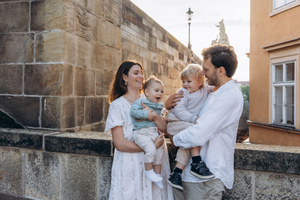 Family enjoying photoshoot on Charles Bridge, Prague