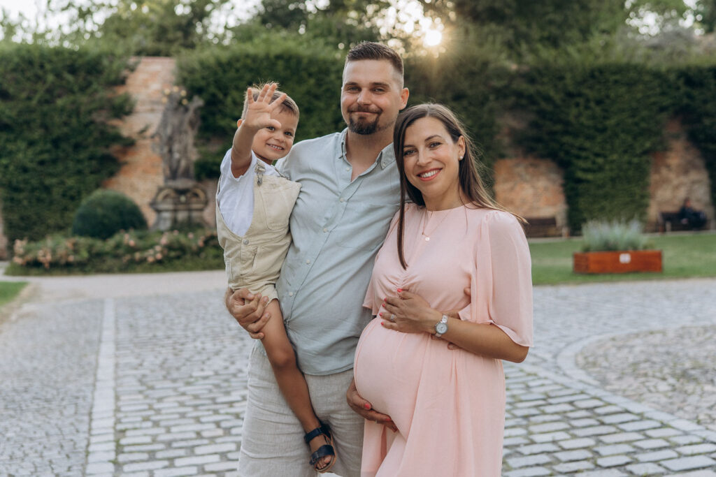 Family pregnancy photoshoot near Břevnov Monastery in warm evening light