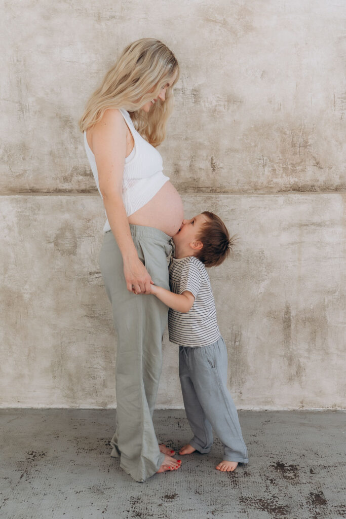 Pregnant mum and toddler son in professional studio photoshoot in Prague