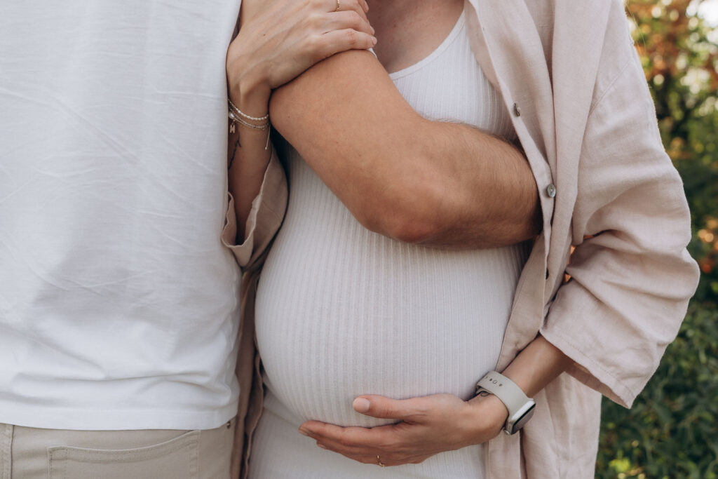 Pregnant woman posing during summer photoshoot in Divoká Šárka, Prague