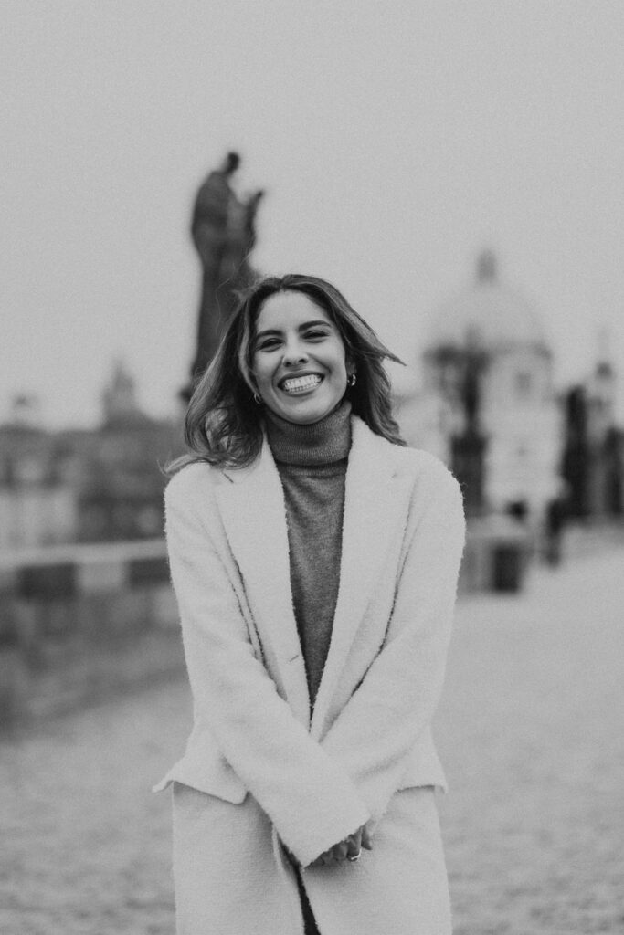 Woman posing for portrait photoshoot on Charles Bridge, Prague