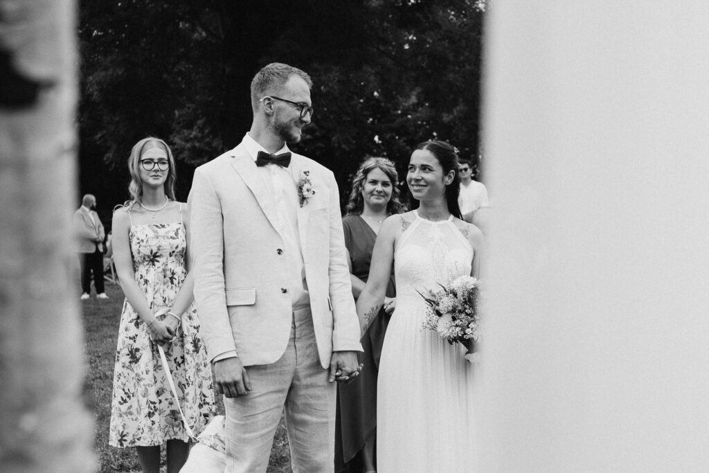 Bride and groom sharing moments during outdoor wedding near Prague