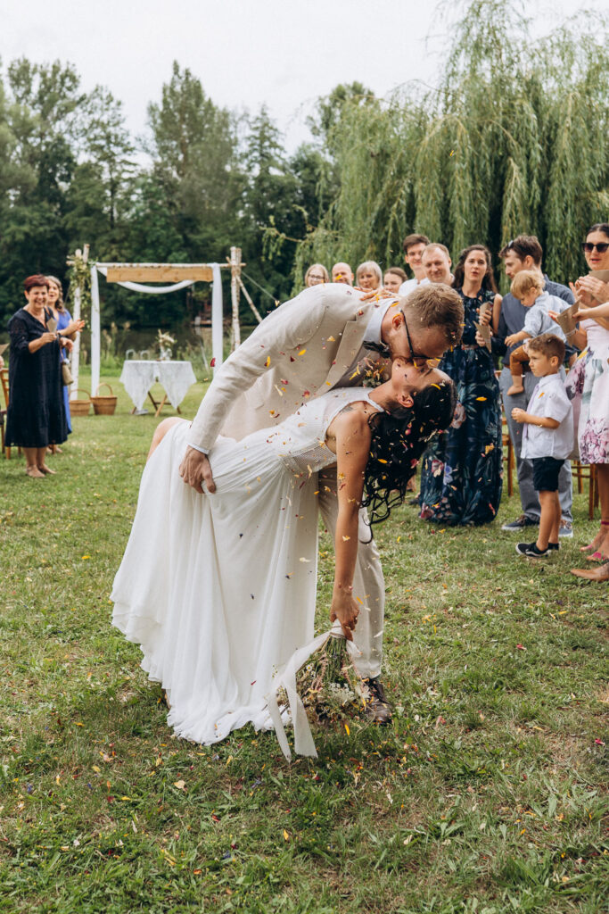 Bride and groom kissing together at outdoor wedding near Prague