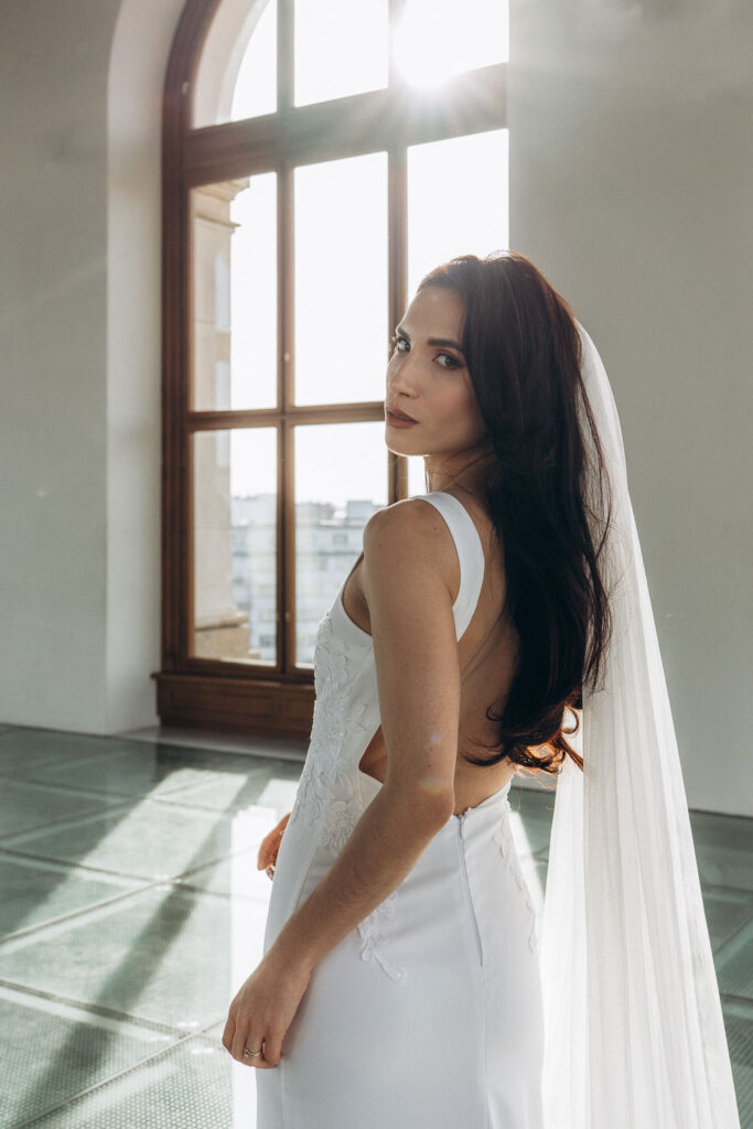 Bride posing for editorial wedding portraits at Prague National Museum