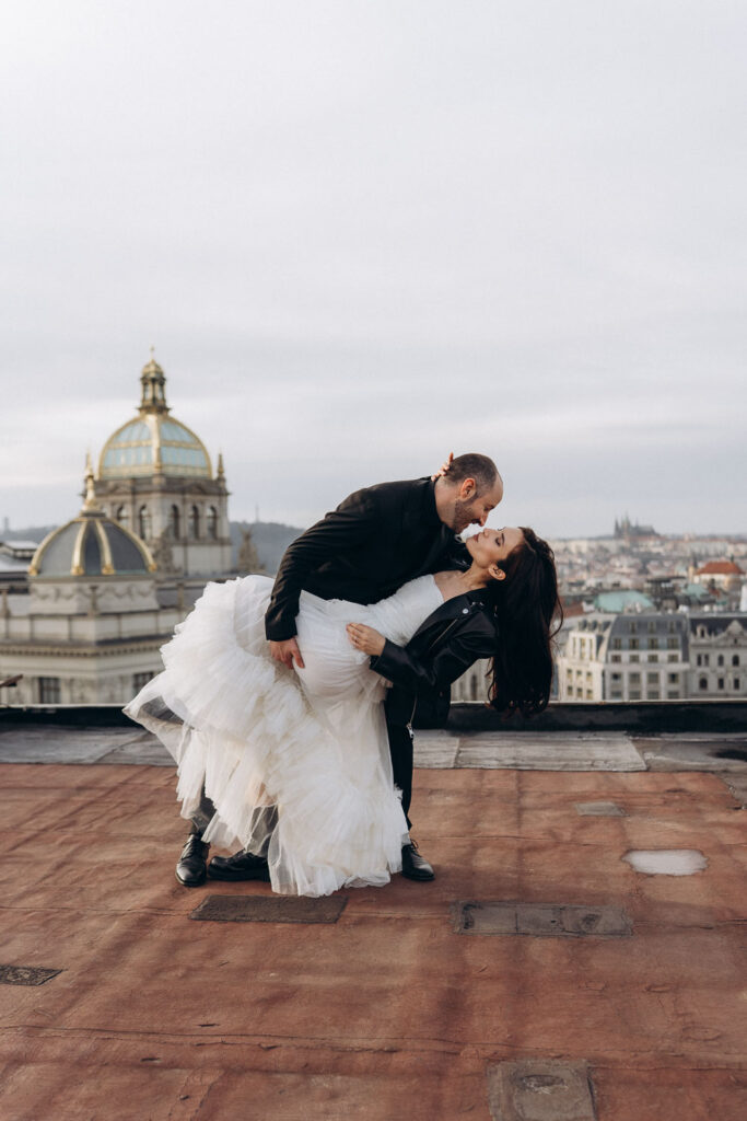 Elegant wedding couple portraits on rooftop near Prague National Museum