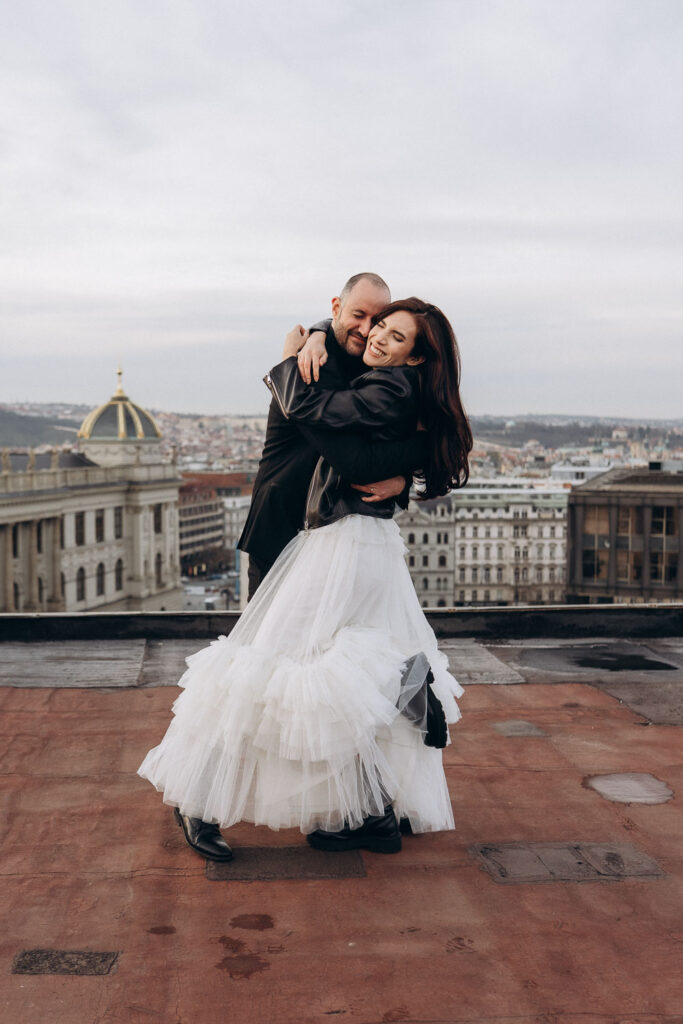Rooftop portraits of bride and groom with Prague National Museum city view