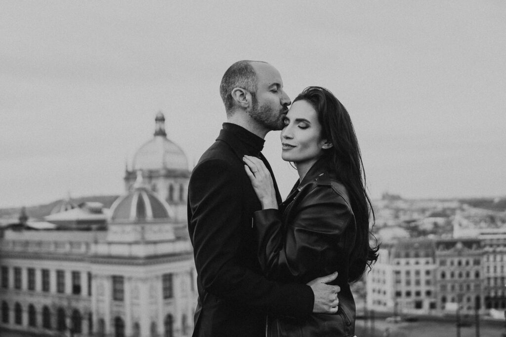 Rooftop wedding portraits with bride, groom, and Prague National Museum backdrop”