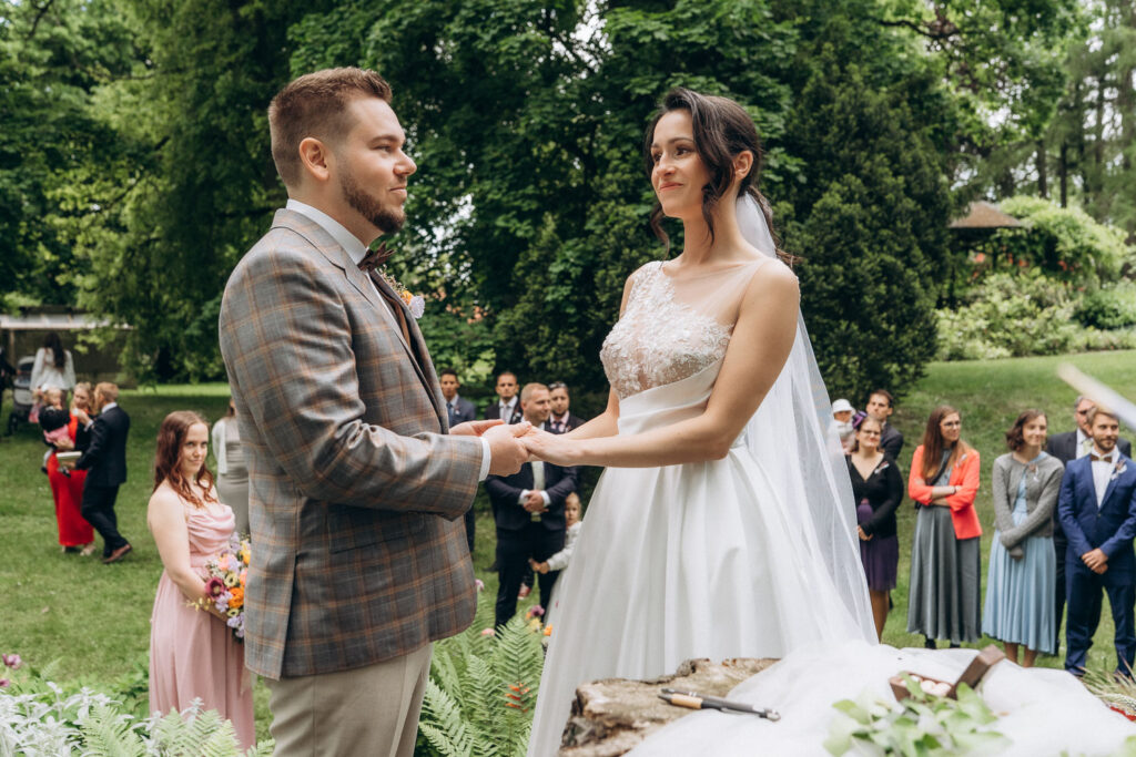 Bride and groom during outdoor wedding in château park near Prague