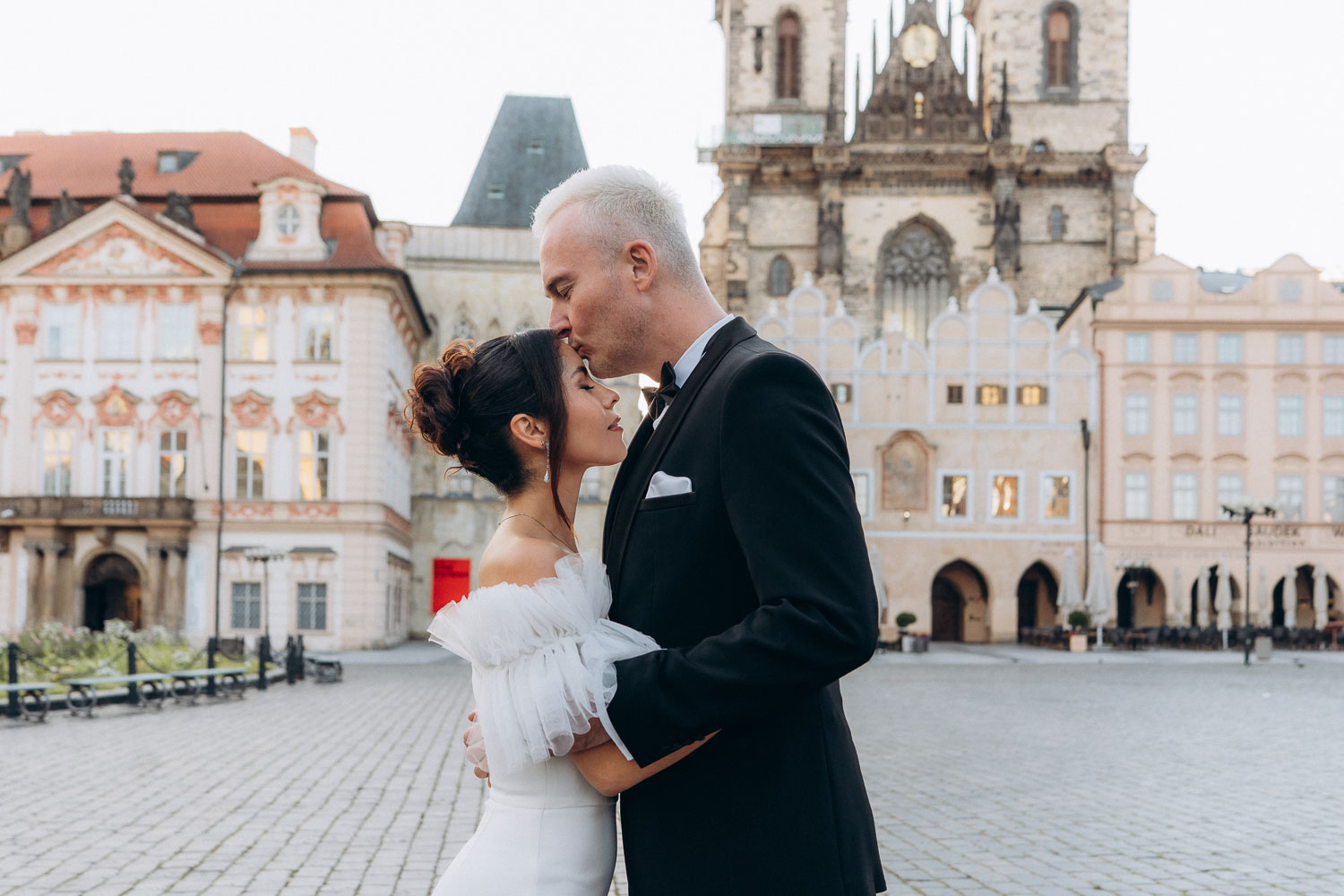 Wedding couple enjoying sunrise in Prague Old Town Square
