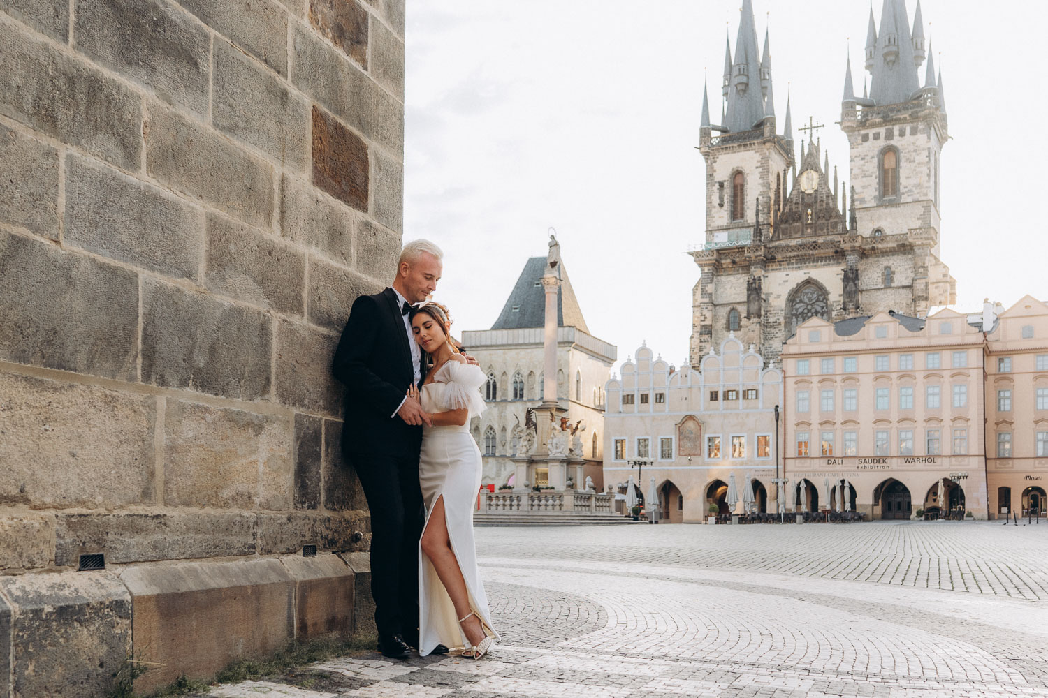 Bride and groom sharing moment during sunrise wedding session in Old Town Square