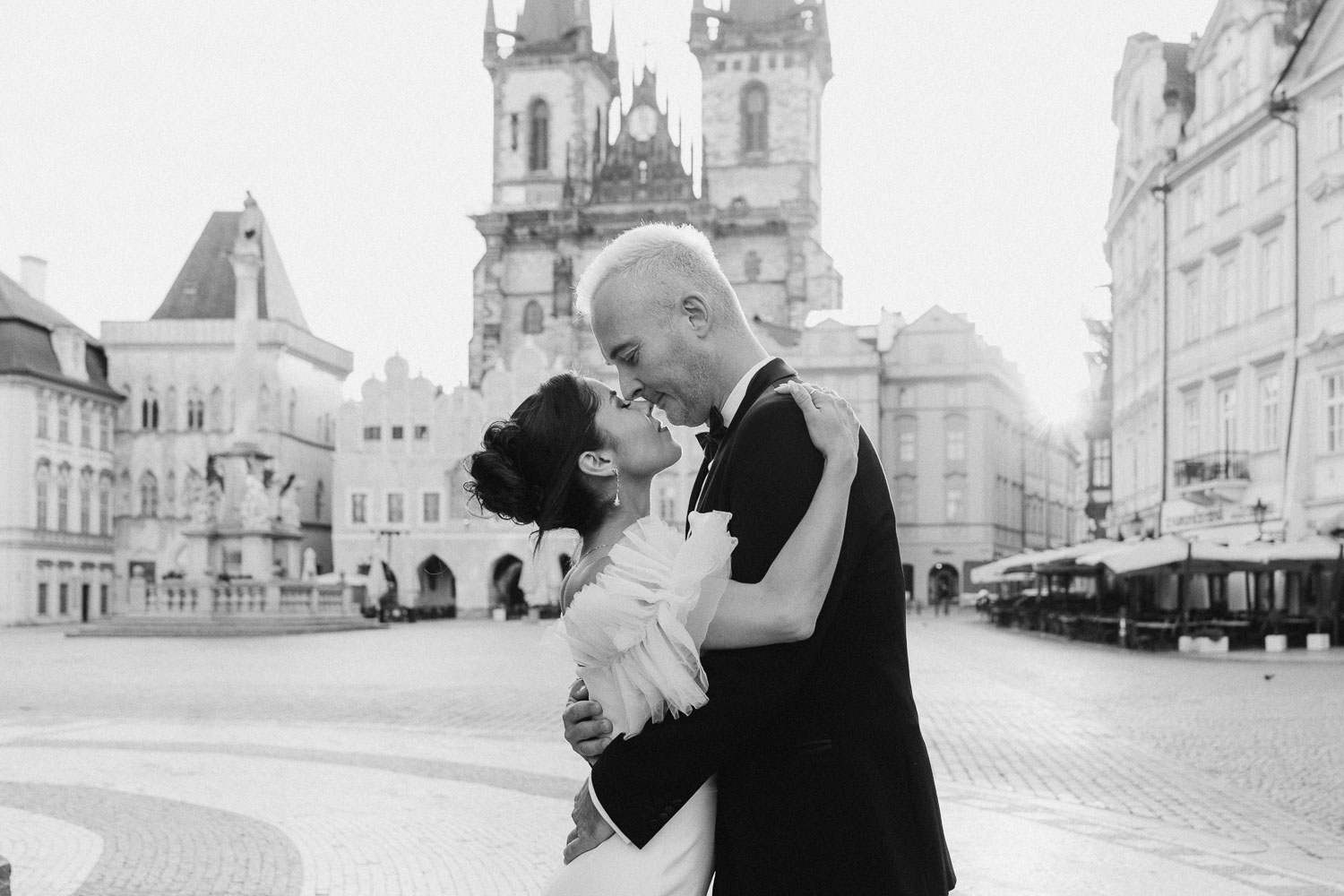 Sunrise wedding session with bride and groom in Prague Old Town Square