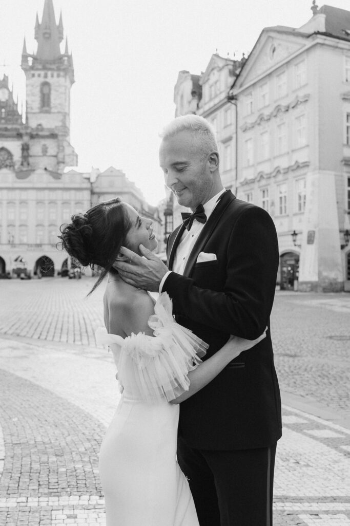 Wedding photography of couple in Old Town Square, Prague at sunrise