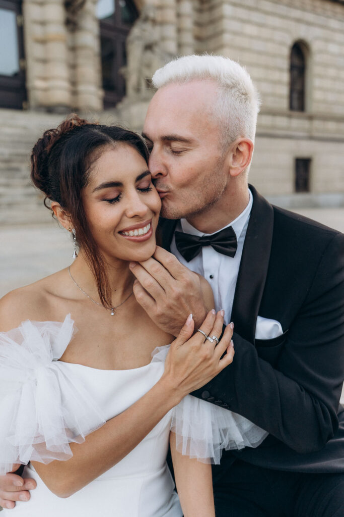 Bride and groom enjoying wedding portrait session at Rudolfinum in Prague