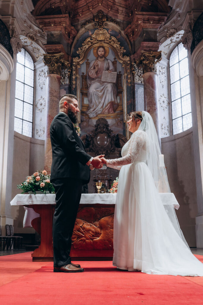 Autumn wedding ceremony inside church in Prague Old Town Square