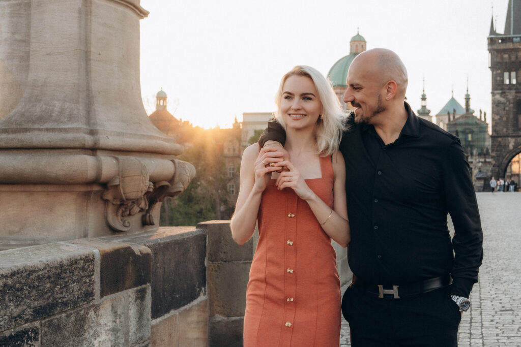Golden sunrise couple photos on Charles Bridge in Prague